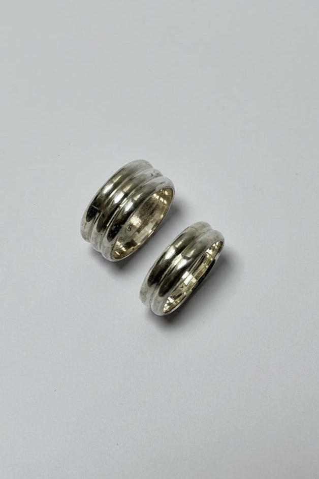 Two silver rings on a light gray background
