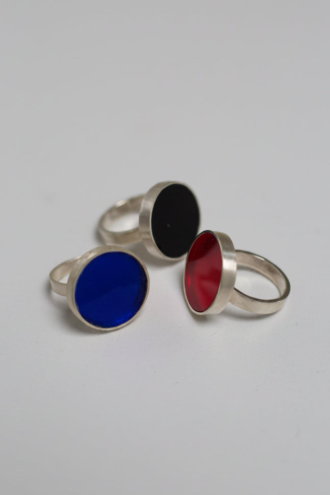 Three rings with colored acrylic on a white background