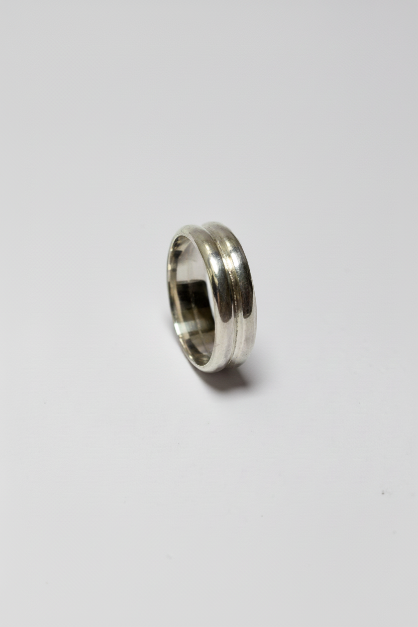 Silver ring on a light gray background