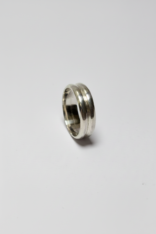 Silver ring on a light gray background