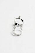 Silver hoop earrings on a light gray background