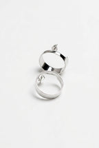 Silver hoop earrings on a light gray background