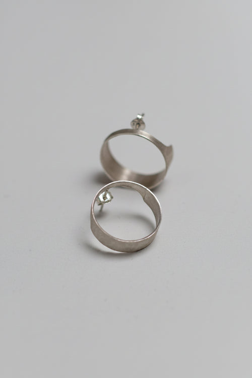 Silver hoop earrings on a light gray background